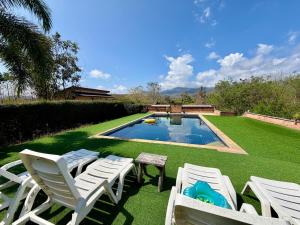 a yard with lawn chairs and a swimming pool at Paihappyvillage in Pai