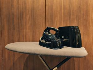 a black tea pot sitting on top of a chair at illi Jam Shinsaibashi in Osaka