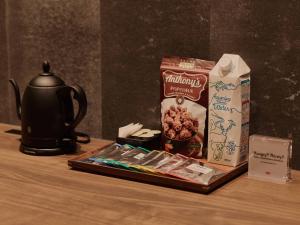 a table with a tea kettle and a box of cereal at illi Jam Shinsaibashi in Osaka