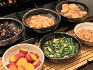 a group of bowls of food on a stove at Hotel Monterey Kyoto in Kyoto