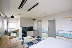 a living room with a couch and a table at ホテル韮崎インター in Nirasaki