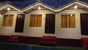a room with a row of chairs and windows at Mountain View Cottage Shivpuri Rishikesh in Rishīkesh