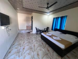 a hotel room with a large bed with a marble floor at Samadhan lodge in Vangani