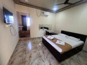 a bedroom with a large bed and a bathroom at Samadhan lodge in Vangani