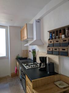 a kitchen with a stove and a counter top at L’escale in Dieulefit +11 photos