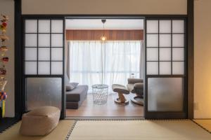 a living room with an open door to a living room at Jupiter 糸島市1棟貸し切り宿 in Itoshima