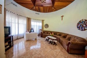 a living room with a couch and a tv at Nazareth Guest House in Kigali