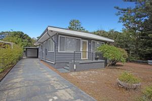 a tiny house in a yard with a driveway at Mermaid Cottage in Hawks Nest