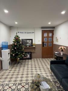 a living room with a christmas tree in front of a fireplace at Morden Apt 6Br Old Quater in Hanoi