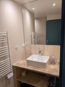 a bathroom with a sink and a mirror at L’escale in Dieulefit