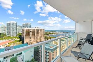 a balcony with chairs and a view of the city at Arya Hotel & Suites in Miami