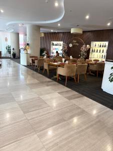 a restaurant with tables and chairs in a room at Grands StarCity in Nha Trang +40 photos