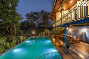 a swimming pool in the backyard of a house at StayVista at Aradhya Villa with Infinity Pool, Lawn in Wayanad