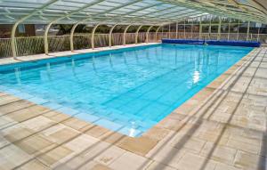a large swimming pool with blue water at Mobile-Home Proche Mer 400M in Grandcamp-Maisy