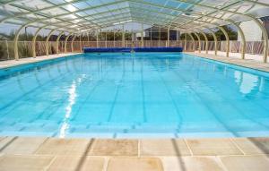 a large swimming pool with a glass ceiling at Mobile-Home Proche Mer 400M in Grandcamp-Maisy +20 photos
