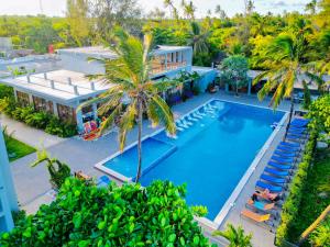 an aerial view of a house with a swimming pool and palm trees at Matemwe Sands Beach Resort in Mkuyuni Pwani