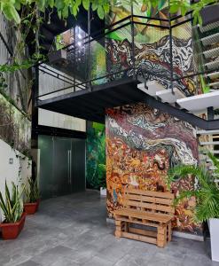 a mural on the wall of a building with a bench at Torre Yaxche Urban Center in Cancún