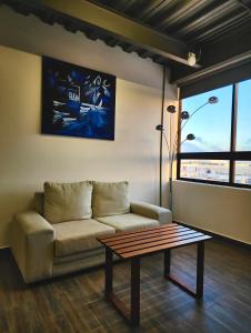 a living room with a couch and a coffee table at Torre Yaxche Urban Center in Cancún