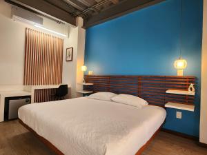 a bedroom with a large bed with a blue wall at Torre Yaxche Urban Center in Cancún