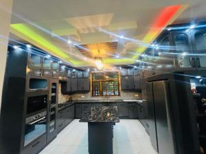 a kitchen with a rainbow painted ceilings and a counter at Alps Villa in Jaffna