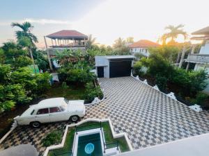 a car parked in the driveway of a house at Alps Villa in Jaffna