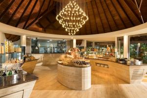 a restaurant with a wine bar and a chandelier at Baros Maldives in Male City