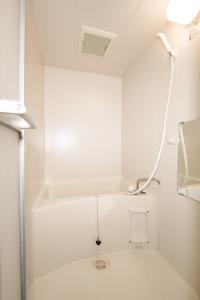a white bathroom with a tub and a shower at b&黒門3号店 in Osaka +37 photos