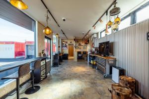 a large room with a bar and some windows at ガレージホテルBeat in Nasushiobara