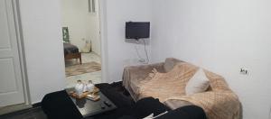 a living room with a couch and a table at Maison de vacance in Bin Rhilouf