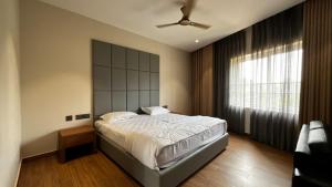 a bedroom with a large bed and a large window at Cloud Nine Hotel - Kuthuparamba in Kūttuparamba +16 photos