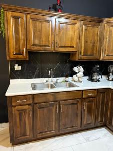 a kitchen with wooden cabinets and a sink at Ancla Suites in Puerto Peñasco +56 photos