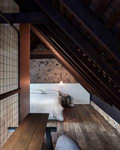 a bedroom with a bed in an attic at The Barn Tasmania in Hobart