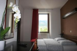 Кровать или кровати в номере Hotel La Portette