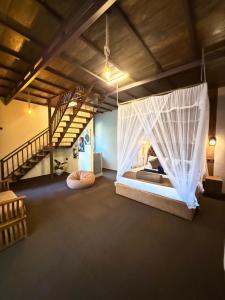 a room with a bed with mosquito net at Serene Homestay Ella in Ella