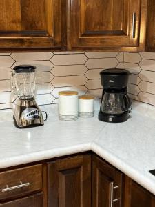 a kitchen counter with a blender and cups on it at Ancla Suites in Puerto Peñasco