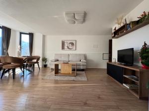 a living room with a couch and a table at Hofgut FeWo & Spa in Wiggensbach