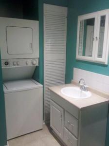 a bathroom with a sink and a washing machine at Cg Beach Bungalow #3 in Myrtle Beach +23 photos
