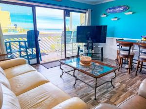 a living room with a couch and a table at Ocean Shores 301 in North Myrtle Beach