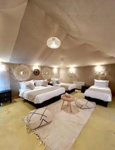 a large bedroom with two beds and a couch at Sahara Gift camp in Merzouga