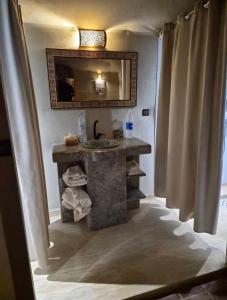 a bathroom with a sink and a mirror at Sahara Gift camp in Merzouga