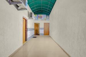 an empty hallway with a green ceiling in a building at FabHotel Aavkar in Sātej