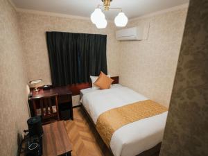 a hotel room with a bed and a window at KANSEI null 佐賀 in Saga