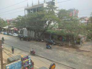 a street with cars and motorcycles on a city street at Shivalik stays in Jorhat
