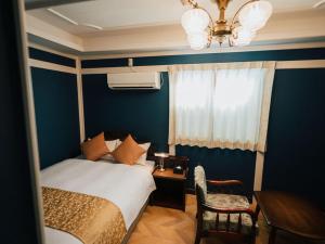 a bedroom with a bed and a table and a window at KANSEI null 佐賀 in Saga +93 photos