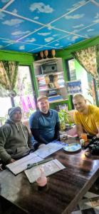 a group of people sitting at a table at Riverside hostel in Ghanpokhara