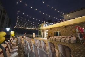 a set up for a wedding with chairs and lights at Lotus Leaf GuestHouse in Guwahati