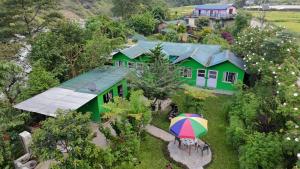 an overhead view of a house with an umbrella at Riverside hostel in Ghanpokhara