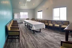 a conference room with a white table and chairs at Alliance Hotel & Suites, a Howard Johnson by Wyndham in Alliance +78 photos