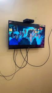 a flat screen tv hanging on a wall at ISIRI Rooms in Mysore