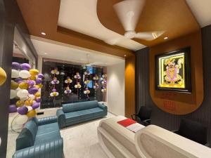 a room with couches and a window with balloons at Hotel Barai Palace in Dwarka